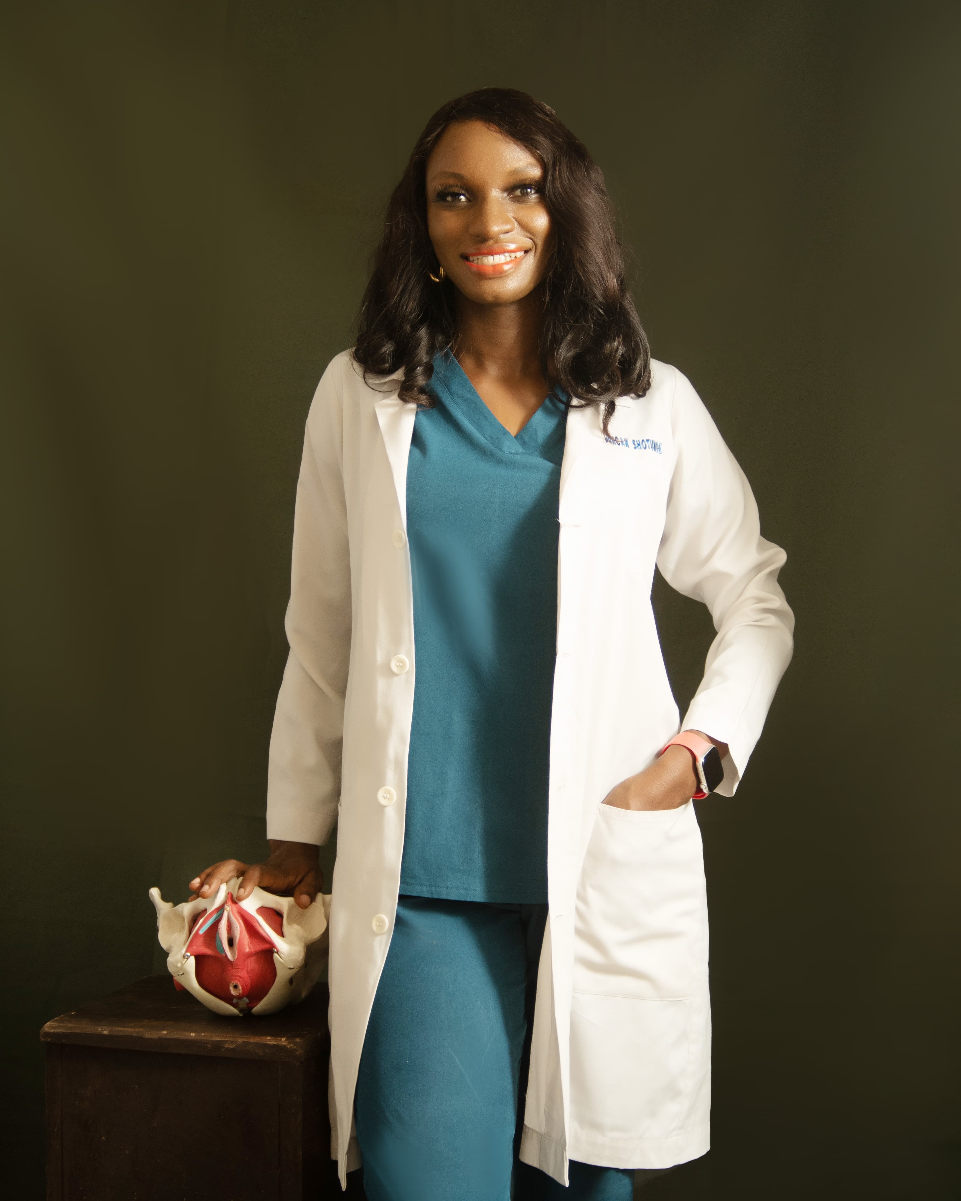 Dr Faith standing beside a pelvic floor teaching model