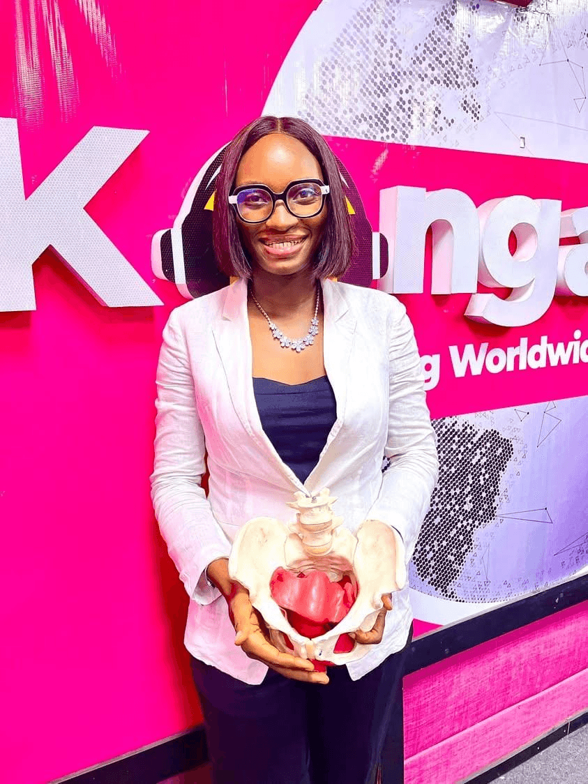 Dr Faith Duncan-Shotunde holding a pelvic anatomy model